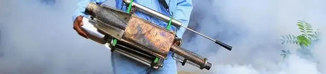 Fumigation technician using a fogger for deep pest treatment in Peoria, IL